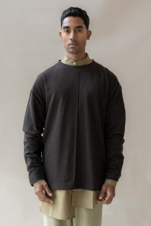 Man modelling contemporary layered outfit.