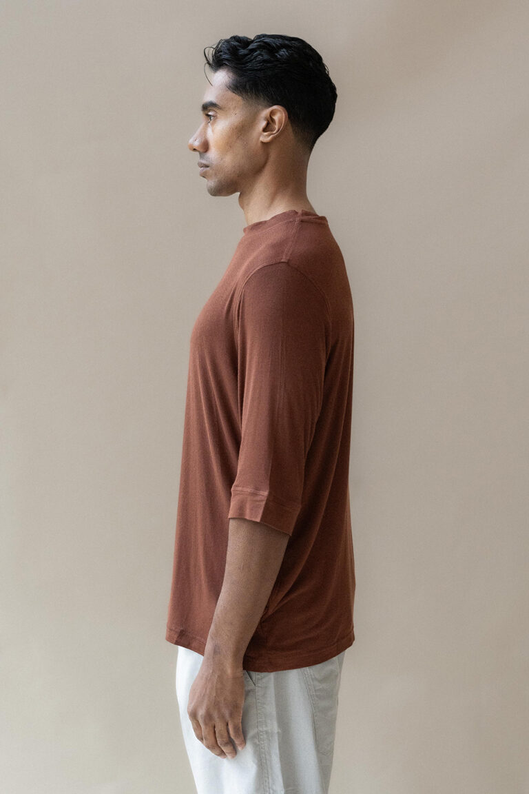 Man in brown t-shirt side profile.